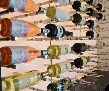 Metal Wine Racks for a Glass Wine Wall Display