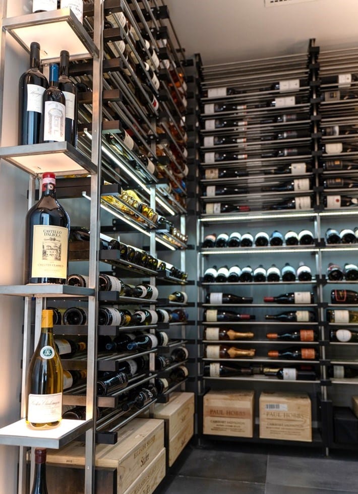 Modern Wine Cellar Under the Stairs Featuring Metal Wine Racks