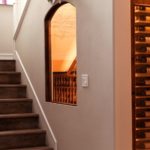 Magnificent Wine Cellar Under-Stairs in an Orange County Home: Combining Wood and Glass Elements