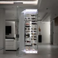 The glass door provides a clear view of your wine closet, while the modern cable wine racks allow air to circulate and stabilize the temperature. Minimalist Glass Home Wine Cellar