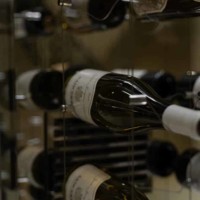 This modern cable racking system for a home wine cellar is designed to be mounted on the wall and can hold multiple bottles of wine. Home Wine Cellar Modern Cable Racking System