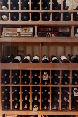 7 - Wooden Wine Racks in a Wine Cellar Under Stairs Displayed for an Orange County Home