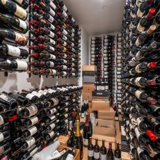 (9) Basement modern wine cellar ideas come to life in this enclosed room featuring minimalist racks, LED lighting, and premium bottle organization.