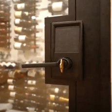 (4) Even the details matter—this matte black hardware is a stylish touch in today’s modern wine cellar door ideas, combining security with sleek minimalism.